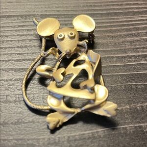 Vintage gold toned brooch featuring mouse holding cheese.